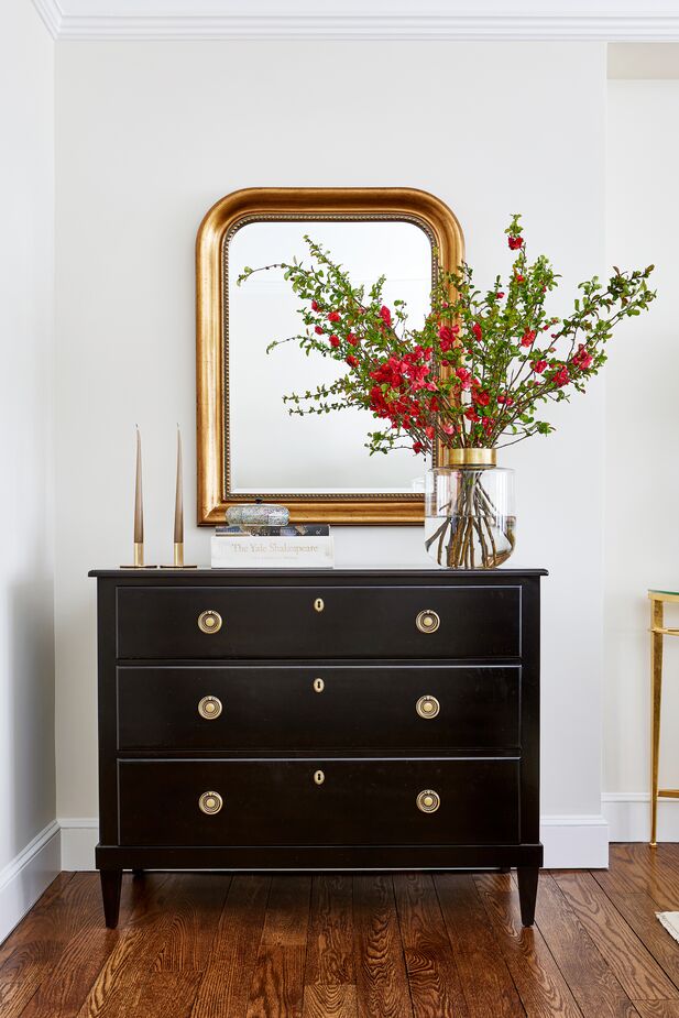 Jordan put the nook just off the living room to good use, bringing in a timeless storage piece that also hosts a decorative tableau. Find the mirror here.
